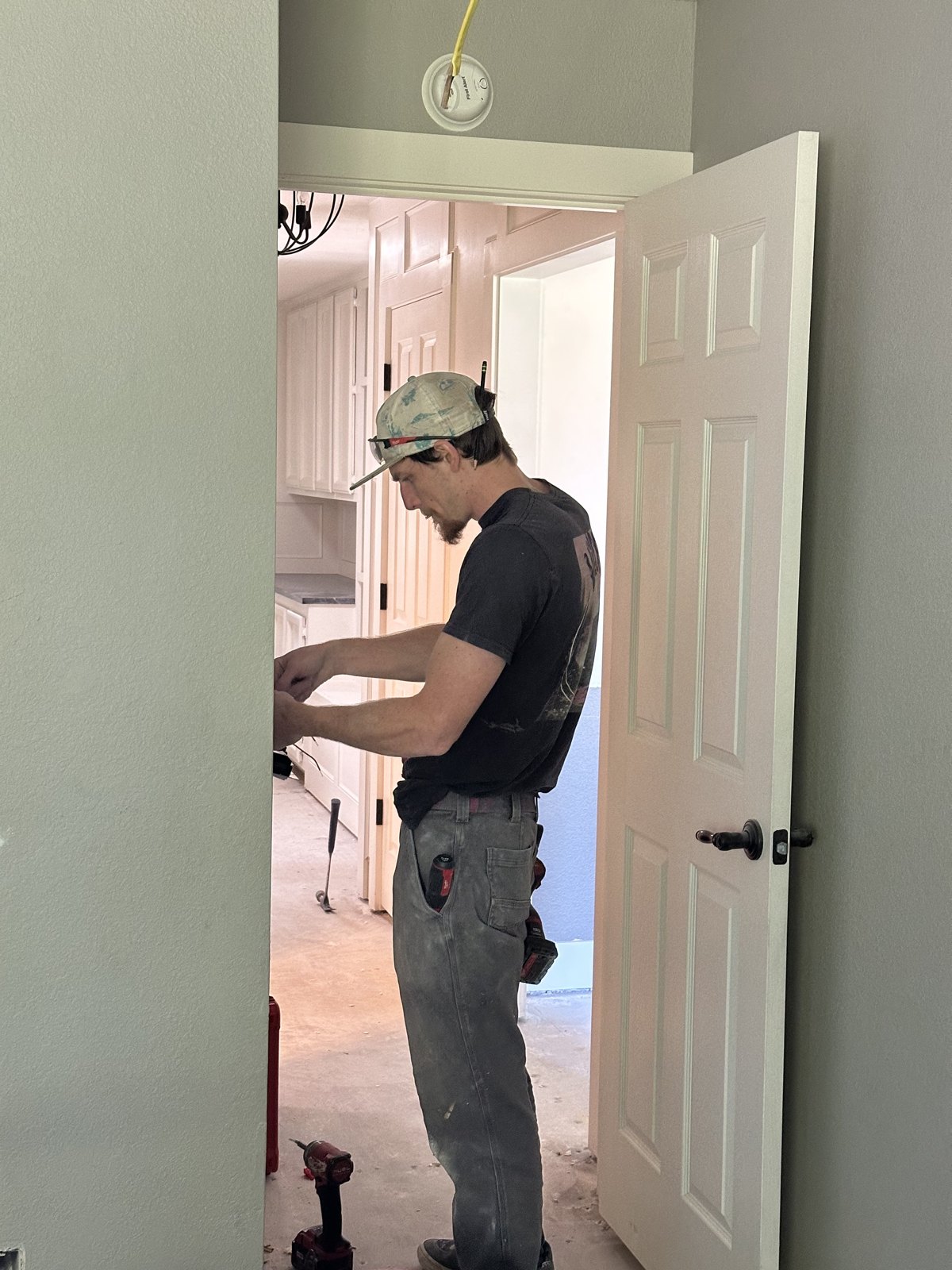Caleb Bonneville installing a wall dimmer switch on a home improvement job